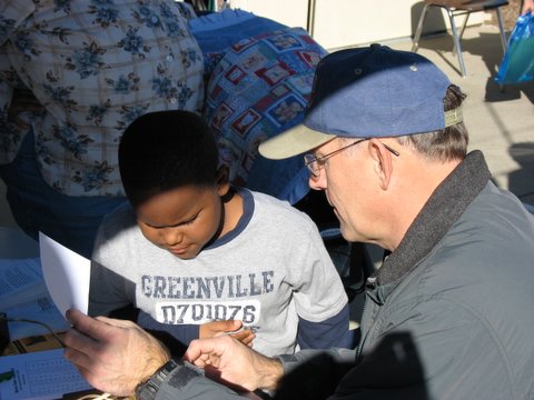 Rick shows morse code to an interested kid